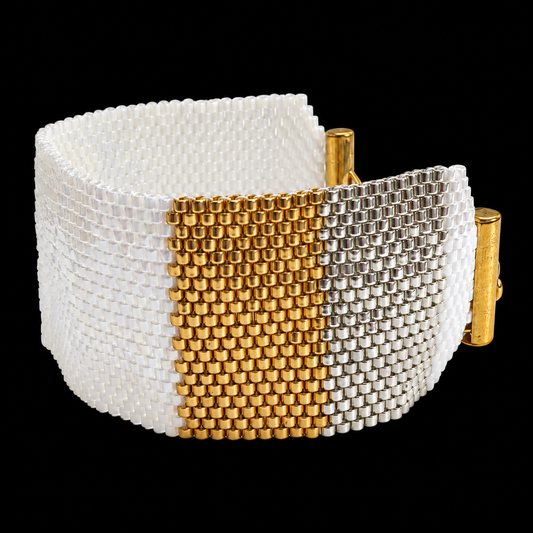 Dailot wide bracelet with pearlescent white beads and gold-tone and silver-tone panels, centered on a black background.