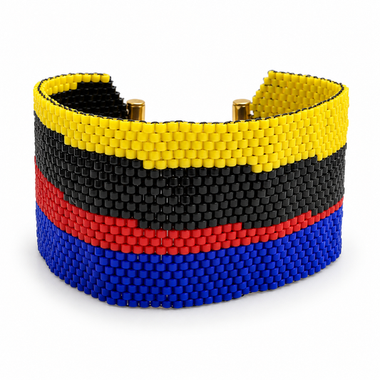 Dailot Maiquetia beaded bracelet with yellow, black, red, and blue horizontal stripes and gold-tone fittings on a white background.