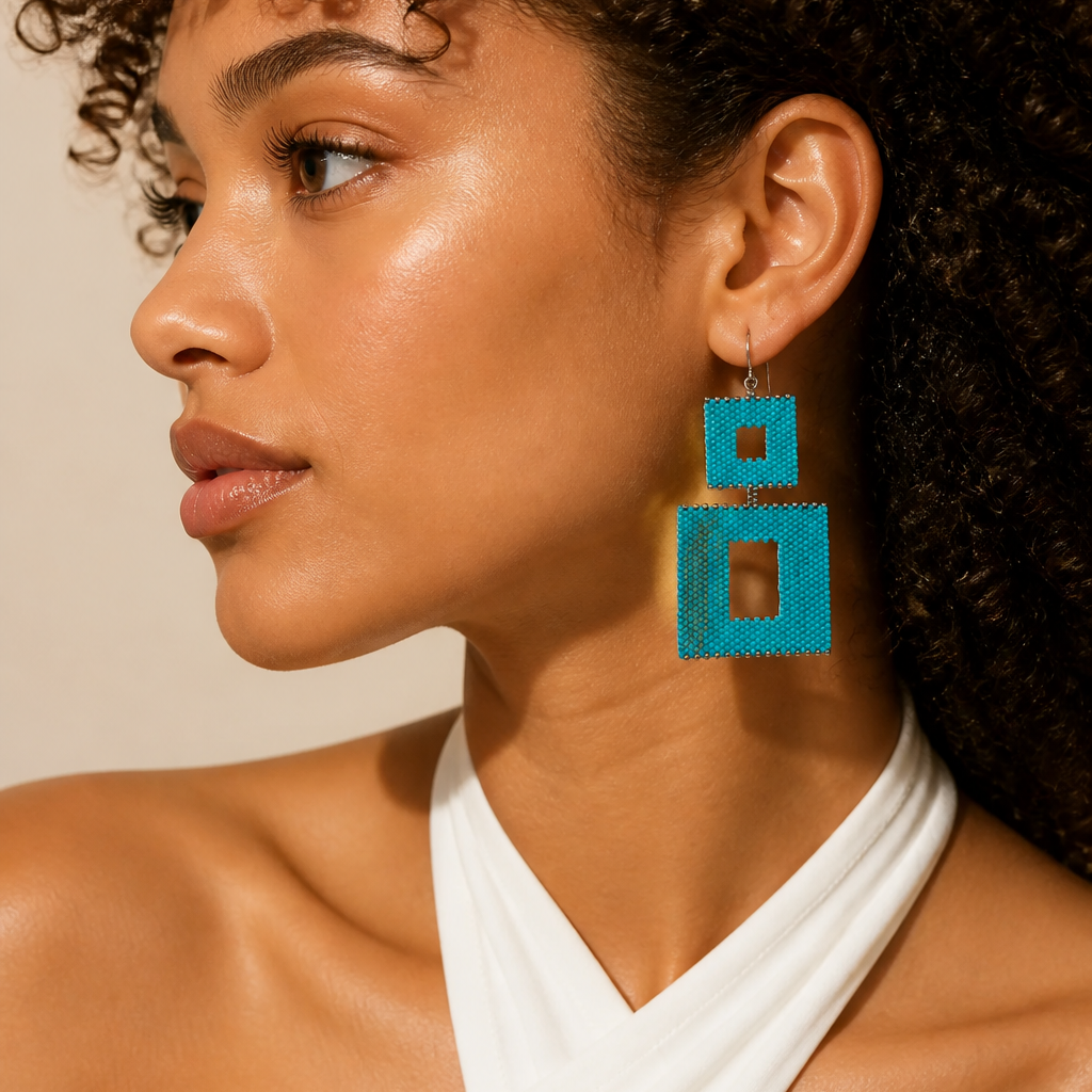 Woman wearing a turquoise beaded earring with two open squares in different sizes
